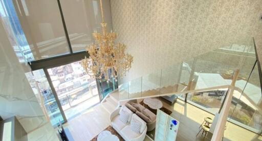 Two-story modern living room with chandelier