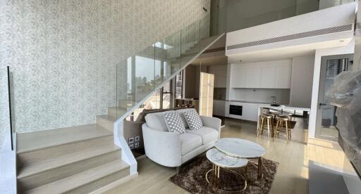 Modern living area with open kitchen and staircase