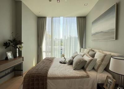 Modern bedroom with large window and elegant decor