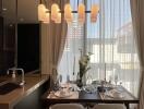 Modern kitchen with dining table setup and pendant lighting