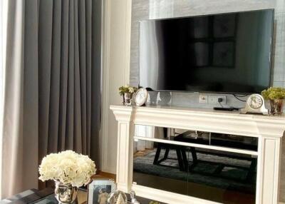 Elegant living room with a television mounted above a decorative fireplace