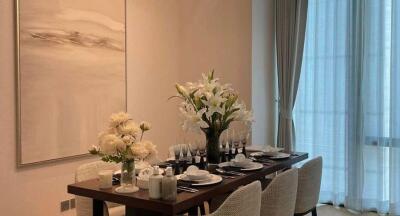 Modern dining room with a well-set dining table and floral centerpiece