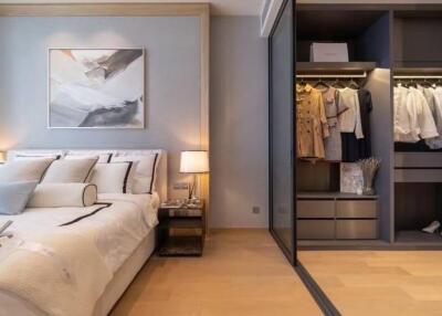 Modern bedroom with large bed and open wardrobe