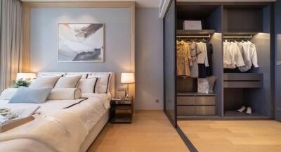 Modern bedroom with large bed and open wardrobe