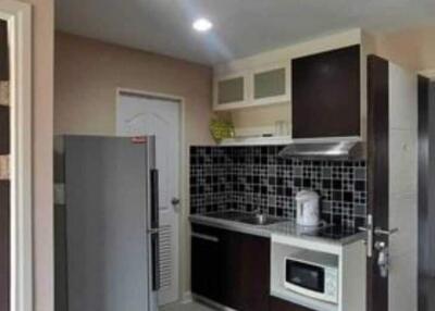 Modern kitchen with dark cabinets and tile backsplash