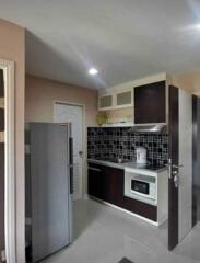 Modern kitchen with dark cabinets and tile backsplash