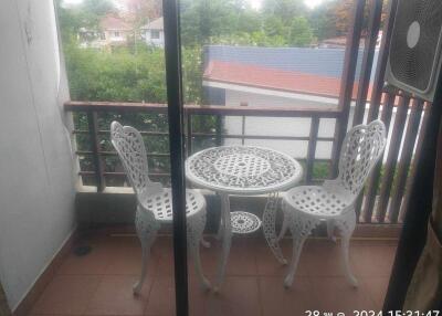 Balcony with white wrought iron table and chairs