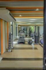 Modern gym with equipment and colorful striped walls