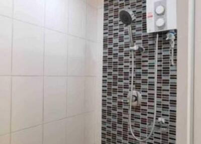 Modern bathroom with tiled shower and water heater