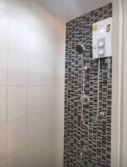 Modern bathroom with tiled shower and water heater