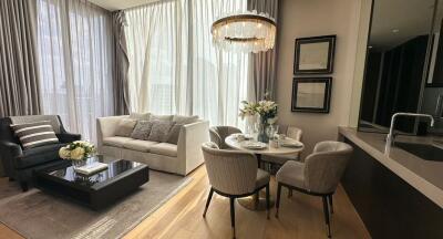 Modern living room with natural light, cozy seating and dining area