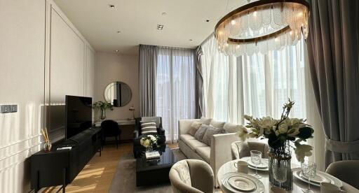 Modern living room with dining area, large windows, and elegant decor