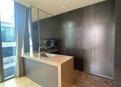 Modern kitchen with dark cabinets and a large window