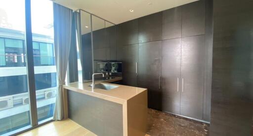 Modern kitchen with dark cabinets and a large window