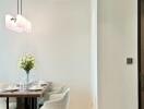 Modern dining area with a wooden table and elegant chairs