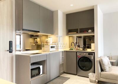 Modern kitchen with built-in appliances and washer-dryer