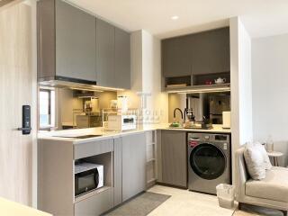 Modern kitchen with built-in appliances and washer-dryer