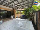 Covered patio area with plants and seating