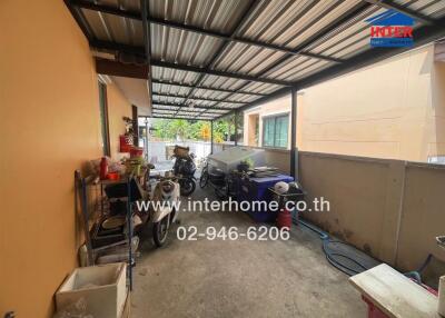 Covered outdoor area with various items and equipment