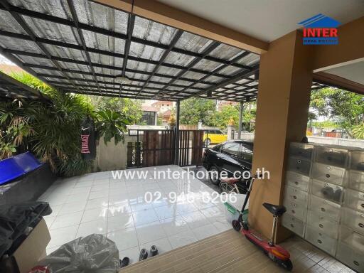 Covered carport with scooter and mailbox area