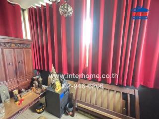 Room with red curtains and wooden furniture