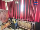 Room with red curtains and wooden furniture