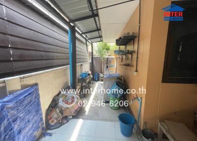 Covered outdoor storage area with various household items