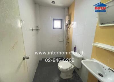 Bathroom with white tiles and basic amenities