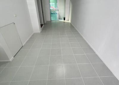 Spacious and well-lit hallway with tiled flooring