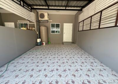 spacious garage with tiled flooring and utility area