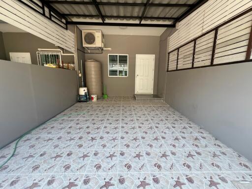 spacious garage with tiled flooring and utility area