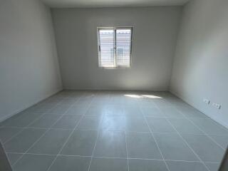 Empty room with tiled floor and window