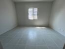 Empty room with tiled floor and window