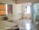 Bedroom with tiled flooring and basic furnishings