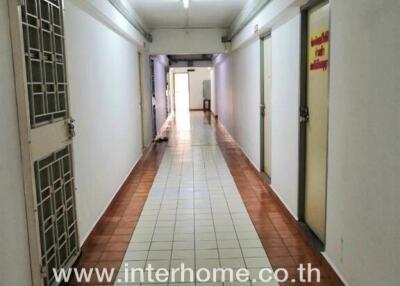 Apartment hallway with doors and tiled flooring