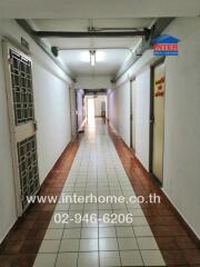 Apartment hallway with doors and tiled flooring