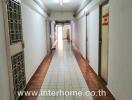 Apartment hallway with doors and tiled flooring