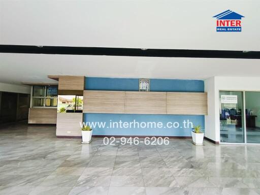 Lobby area with marble flooring and plants