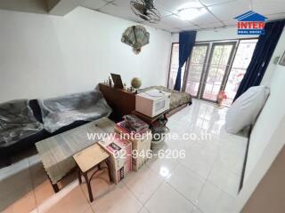 Living room with tile flooring, couch, and large window