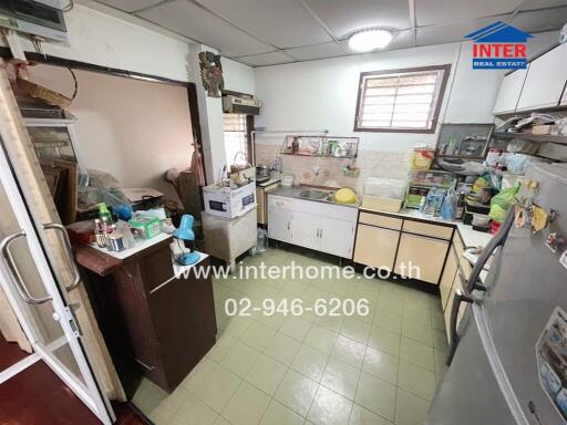 Old kitchen with multiple appliances and storage spaces