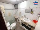 Bathroom with frosted glass shower door, sink, and toilet