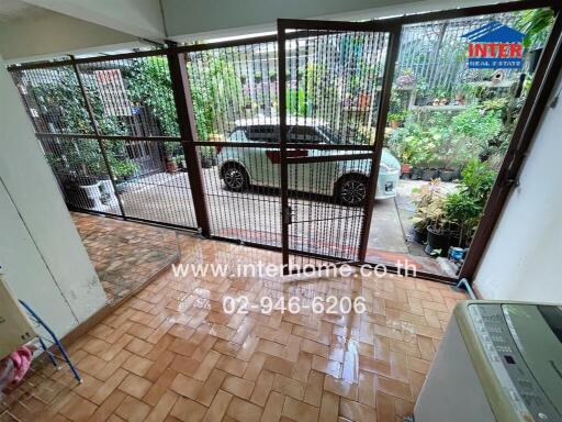 An image showing a garage with a car parked outside