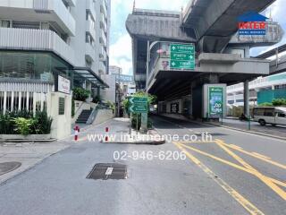 Street view of a building with nearby infrastructure