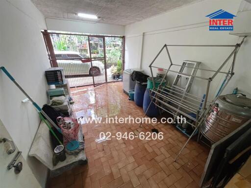 Laundry room with cleaning supplies and equipment in a property