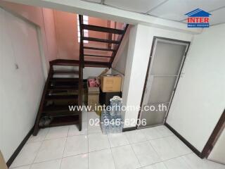 Staircase leading to upper level with storage area
