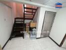 Staircase leading to upper level with storage area