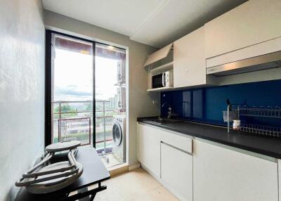 Compact kitchen with modern appliances and a view