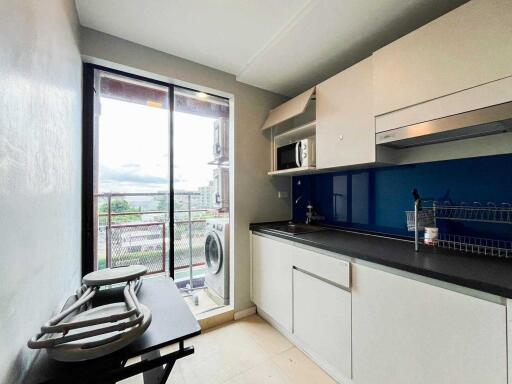 Compact kitchen with modern appliances and a view