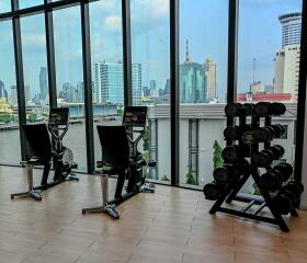 Spacious gym area with equipment and city view