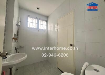 Clean and bright bathroom with white tiles